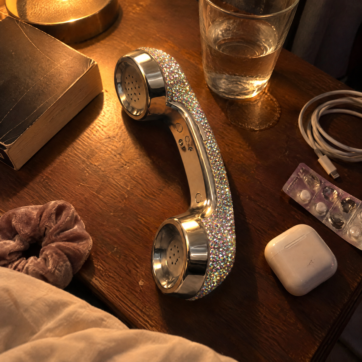 Customer photo of the Chrome Ice Bling Phone on a bedside table